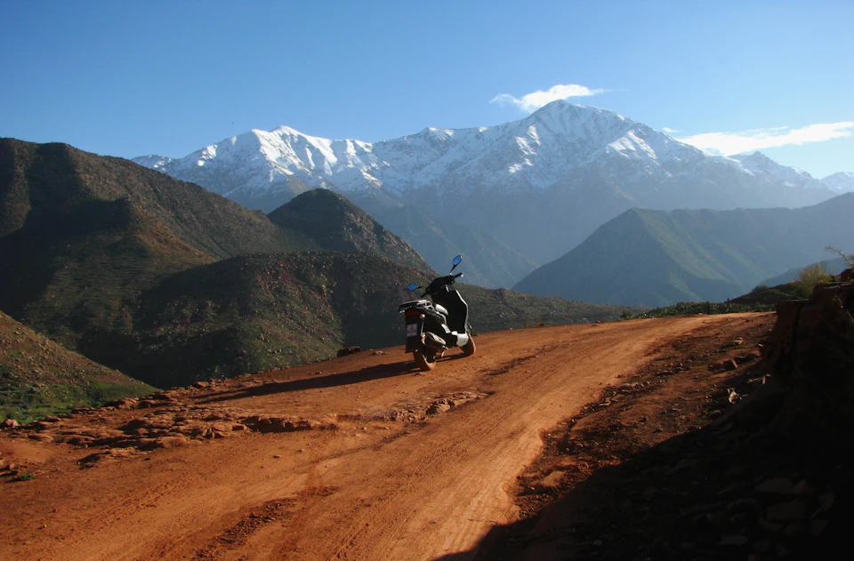 Road leading towards the snowy peaks of the High Atlas, the approach to the Ourika Valley on a day trip from Marrakech