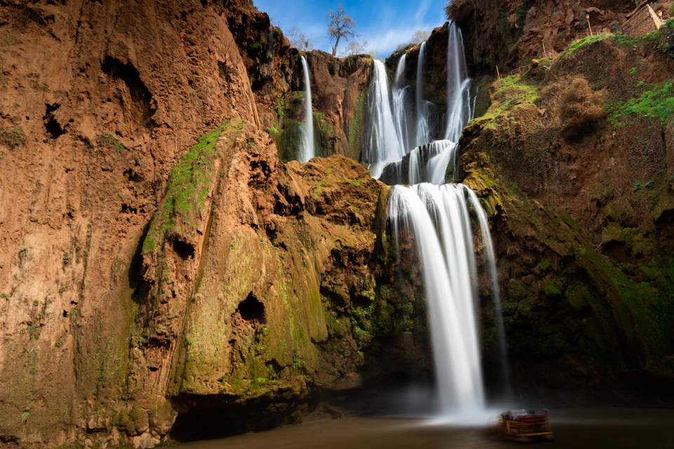 Ouzoud waterfalls dropping into a red-rock gorge, the destination of a full-day trip from Marrakech