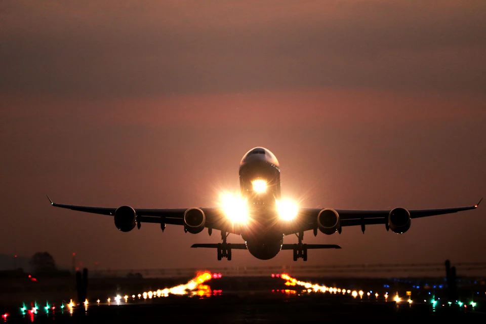 Airliner on final approach at dusk, illustrating the choice of arrival airport for a trip to Morocco