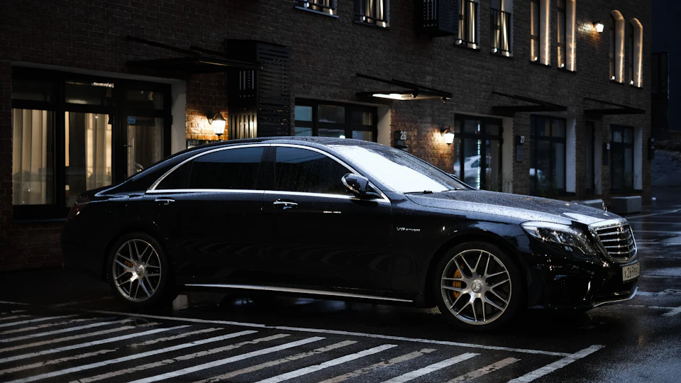 Black executive sedan parked on a city street