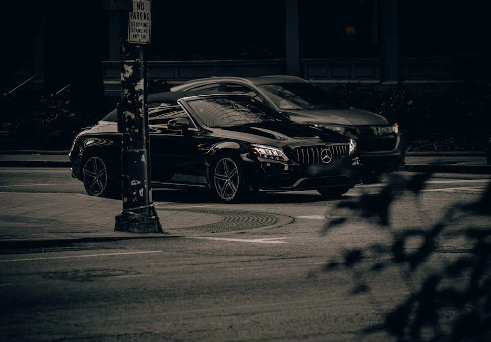 Dark executive car waiting in low light, the kind of vehicle used for a pre-booked private transfer in Morocco.