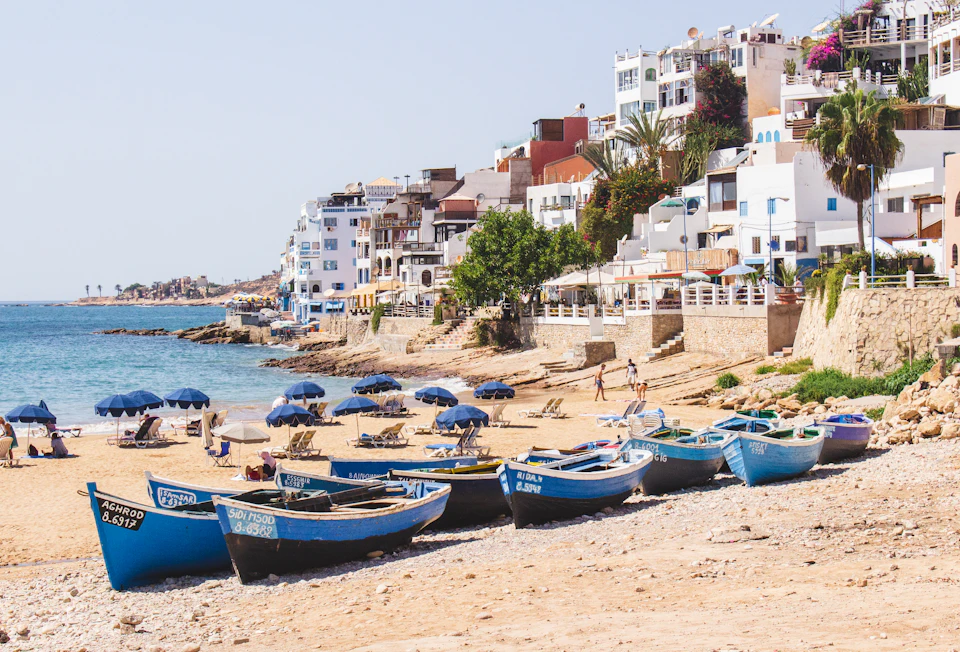 Fishing boats and white houses on Taghazout beach, the surf village reached by road from Marrakech