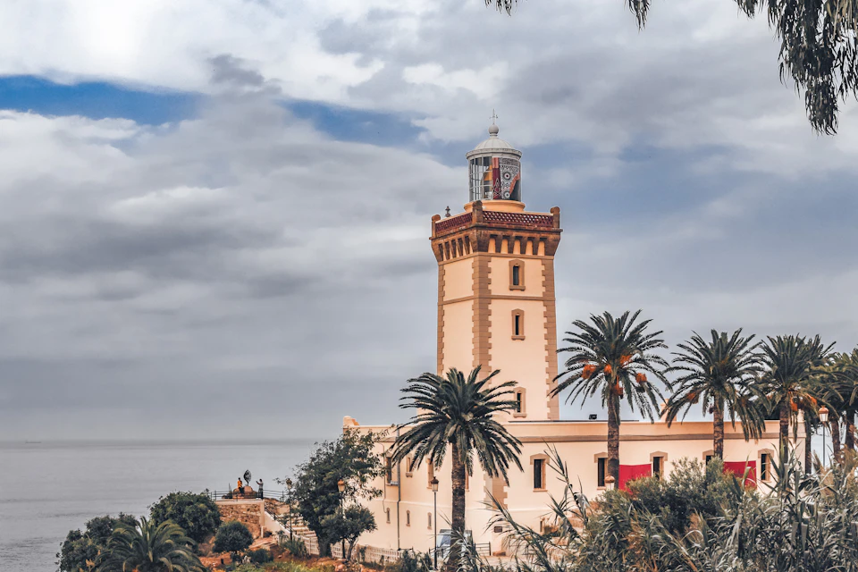 Tangier waterfront with palm trees and a minaret, about 15 km from Tangier Ibn Battouta Airport