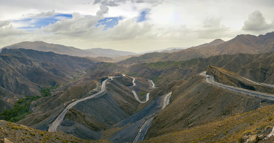 Aerial view of a winding Atlas mountain road, the kind of route that makes driving times in Morocco longer than the map suggests
